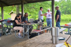 Bill (KD9WEW) operating the GOTA station while Loren (K3RFC) and Glenn (K9GLA)  discusses amateur radio with visitors