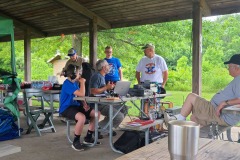 Bill (KD9WEW) and John (KA9CAR) discuss amateur radio with visitors while Jack (W9MU)  and Glenn (K9GLN) observe