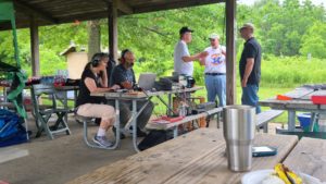 Bill (KD9WEW) operating the GOTA station while Loren (K3RFC) and Glenn (K9GLA)  discusses amateur radio with visitors