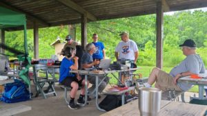 Bill (KD9WEW) and John (KA9CAR) discuss amateur radio with visitors while Jack (W9MU)  and Glenn (K9GLN) observe