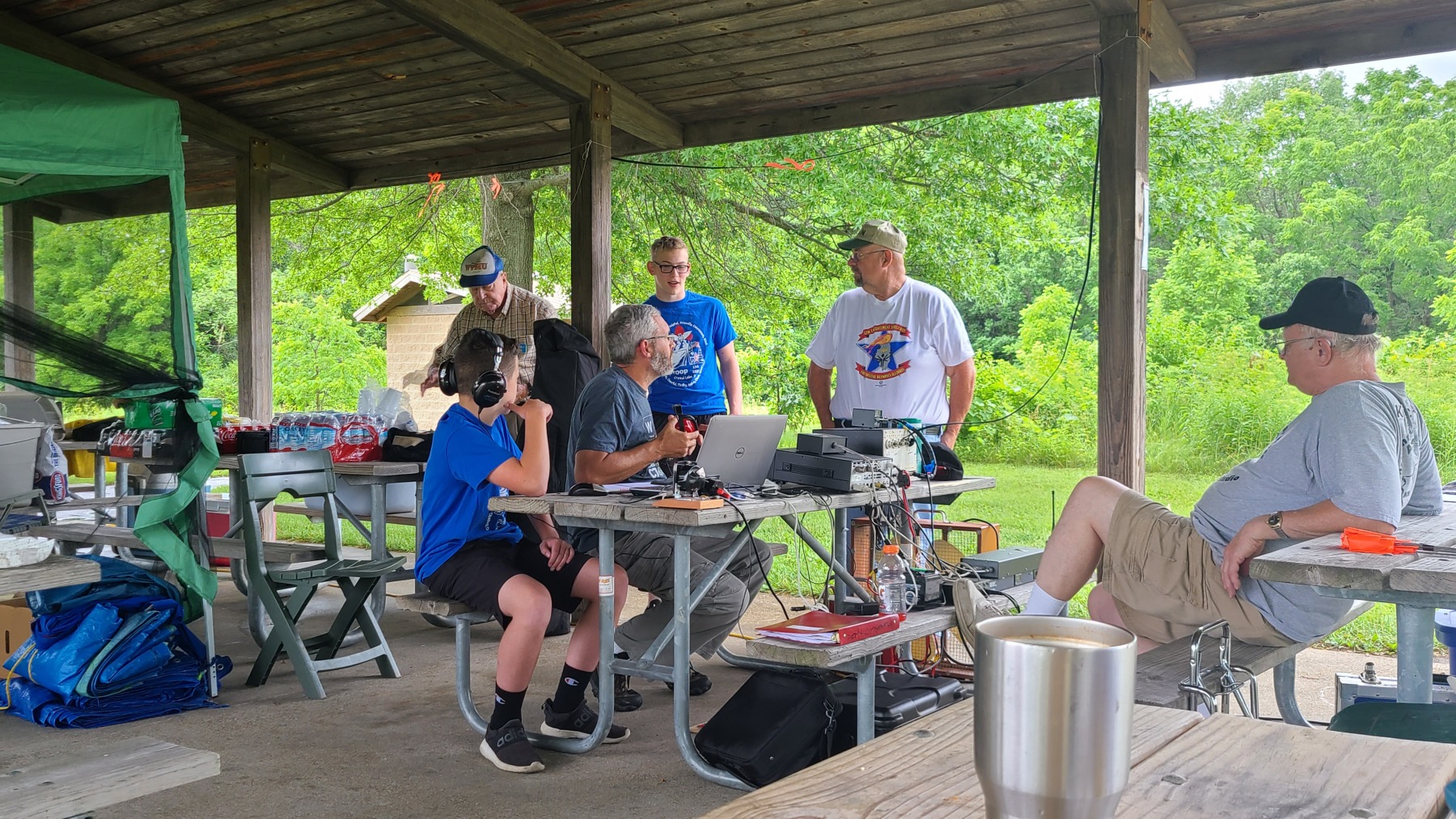Bill (KD9WEW) and John (KA9CAR) discuss amateur radio with visitors while Jack (W9MU) and Glenn (K9GLN) observe