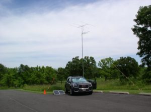 A view of the VHF station and solar panels against a partly cloudy sky - Photo by Fred Soop