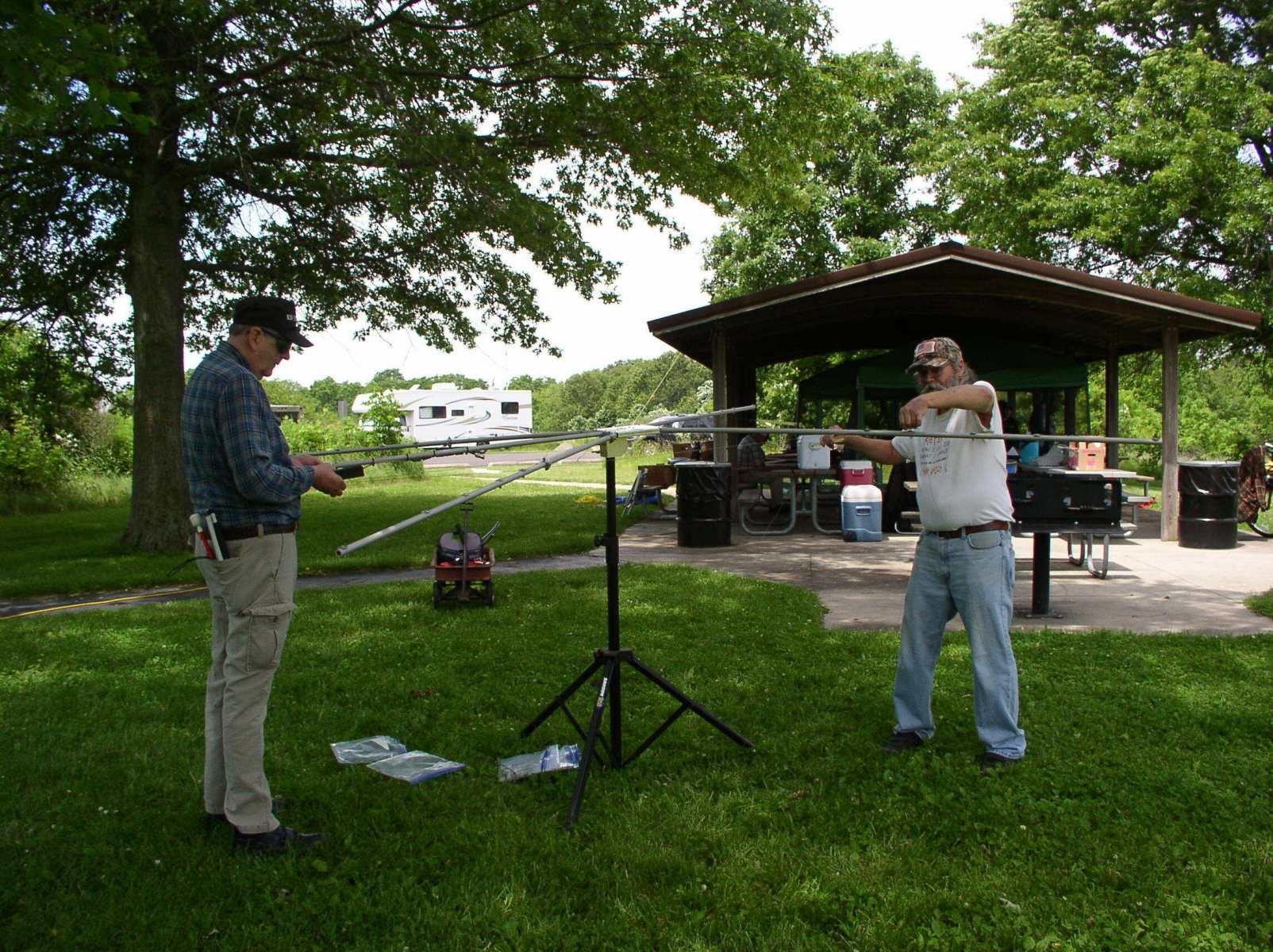 Pierre K9EYE and John KE9NDY continue assembing of the cobweb antenna- - Photo by Fred Soop
