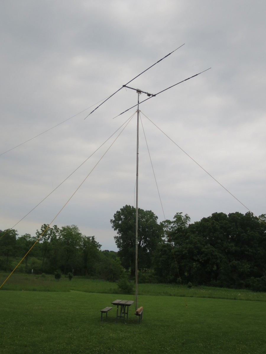 Two element triband CW antenna against a background of a cloudy sky